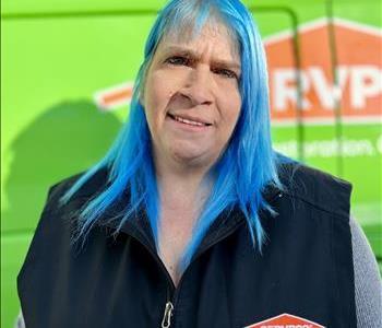 Photo of female SERVPRO employee on a green background